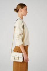 Profile view of model wearing the Oroton Astrid Crossbody in Cream and Pebble leather for Women