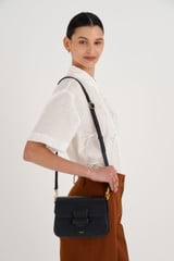 Profile view of model wearing the Oroton Carter Small Day Bag in Black and Smooth leather for Women