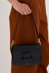 Profile view of model wearing the Oroton Carter Small Day Bag in Black and Smooth leather for Women