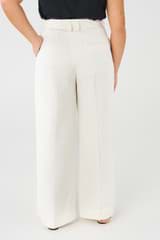Profile view of model wearing the Oroton Pleat Slouch Pant in Cream and 58% viscose, 42% linen for Women