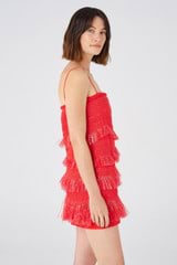 Profile view of model wearing the Oroton Fringed Mini Dress in Poppy and 22.4% polyamide, 28% acrylic, 49.5% polyester for Women