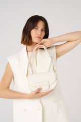 Profile view of model wearing the Oroton Dahlia Saddle Bag in Clotted Cream and Smooth leather for Women