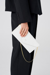Profile view of model wearing the Oroton Louisa Clutch in Pure White and Italian embossed leather for Women