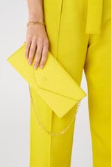 Profile view of model wearing the Oroton Louisa Clutch in Sunshine and Italian embossed leather for Women