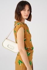 Profile view of model wearing the Oroton Oro Baguette in Clotted Cream and Smooth leather for Women