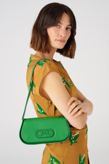 Profile view of model wearing the Oroton Oro Baguette in Jewel Green and Smooth leather for Women