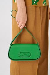 Profile view of model wearing the Oroton Oro Baguette in Jewel Green and Smooth leather for 