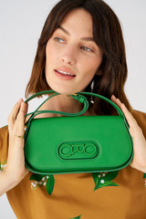 Profile view of model wearing the Oroton Oro Baguette in Jewel Green and Smooth leather for Women