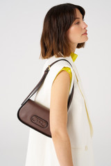 Profile view of model wearing the Oroton Oro Baguette in Bear Brown and Smooth leather for Women