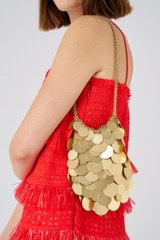 Profile view of model wearing the Oroton Vera Circular Paillettes Bag in Worn Gold and 100% metal for Women