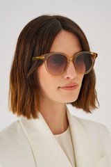 Profile view of model wearing the Oroton Raleigh Sunglasses in Tan and Acetate for Women
