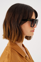 Profile view of model wearing the Oroton Easton Polarised Sunglasses in Signature Tort and Bio acetate (Biodegradeable) for Women