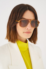 Profile view of model wearing the Oroton Folk Sunglasses in Maple Tort and Acetate for Women