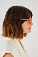 Profile view of model wearing the Oroton Folk Sunglasses in Rust and Acetate for Women
