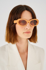 Profile view of model wearing the Oroton Daphne Sunglasses in Clay and Acetate for 