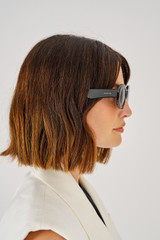 Profile view of model wearing the Oroton Daphne Sunglasses in Black and Acetate for Women