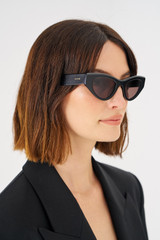 Profile view of model wearing the Oroton Rey Sunglasses in Black and Acetate for Women