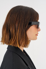 Profile view of model wearing the Oroton Rey Sunglasses in Black and Acetate for Women