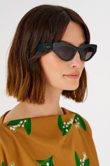 Profile view of model wearing the Oroton Rey Sunglasses in Treehouse and Acetate for Women