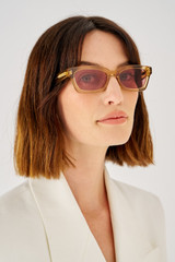 Profile view of model wearing the Oroton Wilder Sunglasses in Tan and Acetate for Women