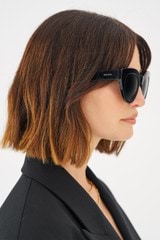 Profile view of model wearing the Oroton Dallas Polarised Sunglasses in Black and Acetate for 