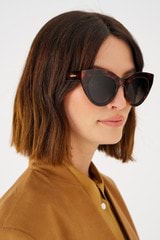 Profile view of model wearing the Oroton Dallas Polarised Sunglasses in Signature Tort and Acetate for 