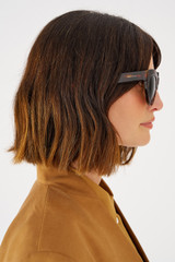 Profile view of model wearing the Oroton Dallas Polarised Sunglasses in Signature Tort and Acetate for Women