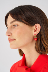 Profile view of model wearing the Oroton Bowman Small Cluster Earrings in Worn Gold/Poppy and Brass base metal for Women
