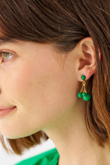 Profile view of model wearing the Oroton Bowman Small Cluster Earrings in Worn Gold/Jewel Green and Brass base metal for Women
