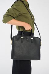 Profile view of model wearing the Oroton Anika 16" Laptop Bag in Black and Pebble Leather for Women