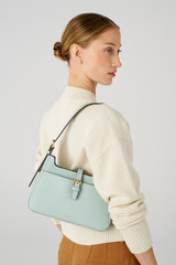 Profile view of model wearing the Oroton Dylan Baguette in Duck Egg and Pebble leather, smooth leather trims for Women