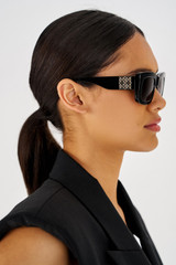 Profile view of model wearing the Oroton Alice Sunglasses in Black and Acetate for Women