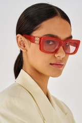Profile view of model wearing the Oroton Alice Sunglasses in Rust and Acetate for Women