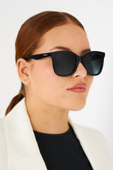 Profile view of model wearing the Oroton Brook Polarised Sunglasses in Black and Bio acetate (Biodegradeable) for Women