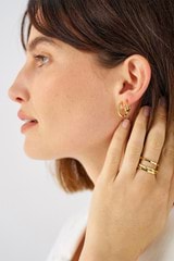 Profile view of model wearing the Oroton Fife Hoops in 18K Gold and Sustainably sourced 925 Sterling Silver for Women