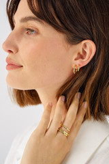 Profile view of model wearing the Oroton Fife Huggies in 18K Gold and Recycled 925 Sterling Silver for Women