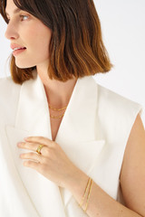 Profile view of model wearing the Oroton Fife Bracelet in 18K Gold and Sustainably sourced 925 Sterling Silver for Women