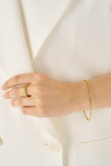 Profile view of model wearing the Oroton Fife Bracelet in 18K Gold and Recycled 925 Sterling Silver for Women