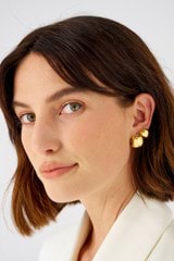 Profile view of model wearing the Oroton Josie Mini Huggies in 18K Gold and Sustainably sourced 925 Sterling Silver for Women