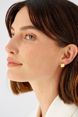 Profile view of model wearing the Oroton Josie Mini Huggies in 18K Gold and Recycled 925 Sterling Silver for Women