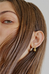 Profile view of model wearing the Oroton Kora Mini Hoops in 18K Gold and Recycled 925 Sterling Silver for Women