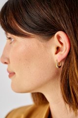 Profile view of model wearing the Oroton Kora Mini Hoops in 18K Gold and Sustainably sourced 925 Sterling Silver for Women
