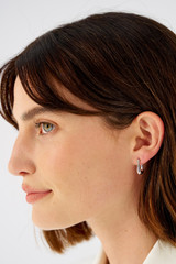 Profile view of model wearing the Oroton Kora Mini Hoops in Silver and Recycled 925 Sterling Silver for Women