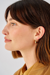 Profile view of model wearing the Oroton Kora Hoops in 18K Gold and Sustainably sourced 925 Sterling Silver for Women