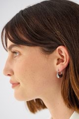 Profile view of model wearing the Oroton Kora Hoops in Silver and Sustainably sourced 925 Sterling Silver for Women