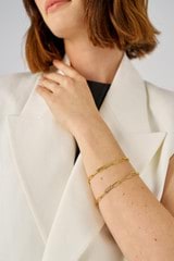 Profile view of model wearing the Oroton Gianna Paper Link Chain Bracelet in 18K Gold and Recycled 925 Sterling Silver for Women