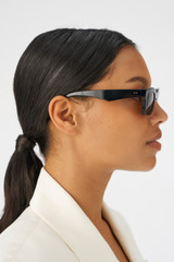 Profile view of model wearing the Oroton Wilder Polarised Sunglasses in Black and Bio acetate (Biodegradeable) for Women