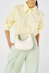 Profile view of model wearing the Oroton Clara Mini Bag in Paper White and Pebble leather for Women