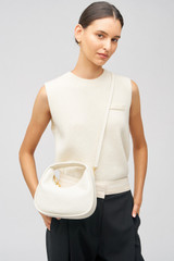 Profile view of model wearing the Oroton Clara Mini Bag in Paper White and Pebble leather for Women