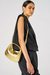 Profile view of model wearing the Oroton Clara Mini Bag in Gold and Metallic crinkle leather for Women